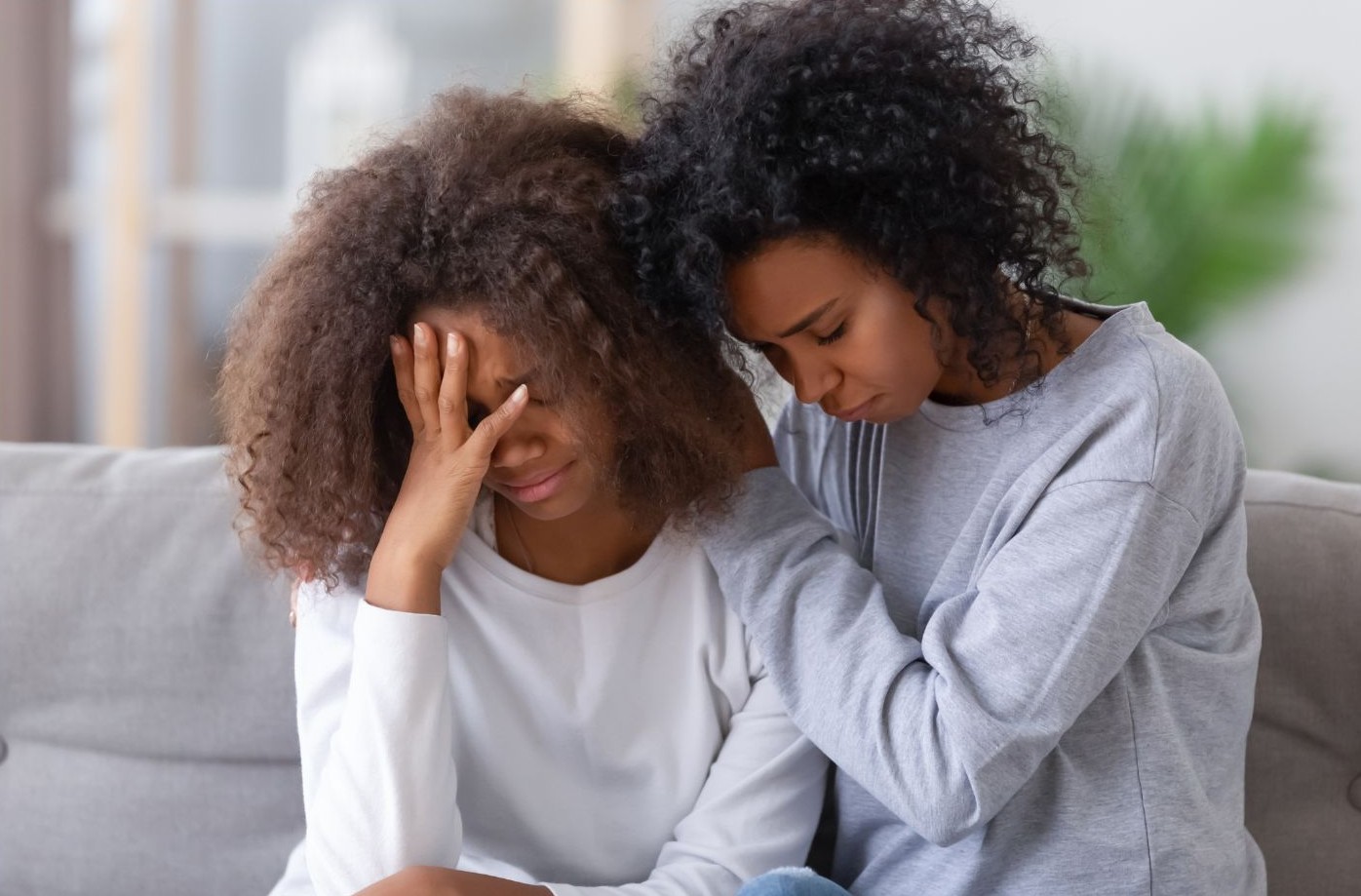 Daughter comforting mother